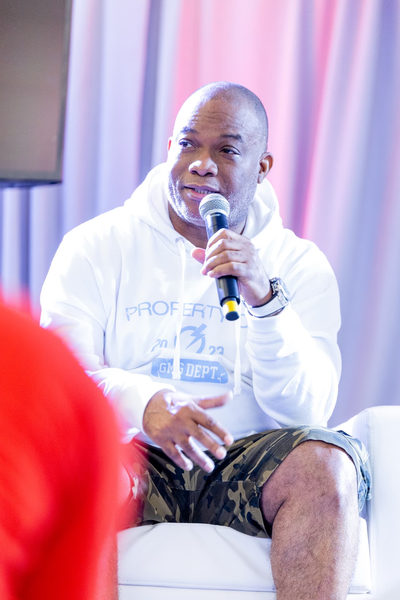 Troy McNair Sr. speaking on stage with a microphone